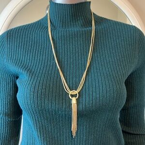 Triple strand gold colored necklace